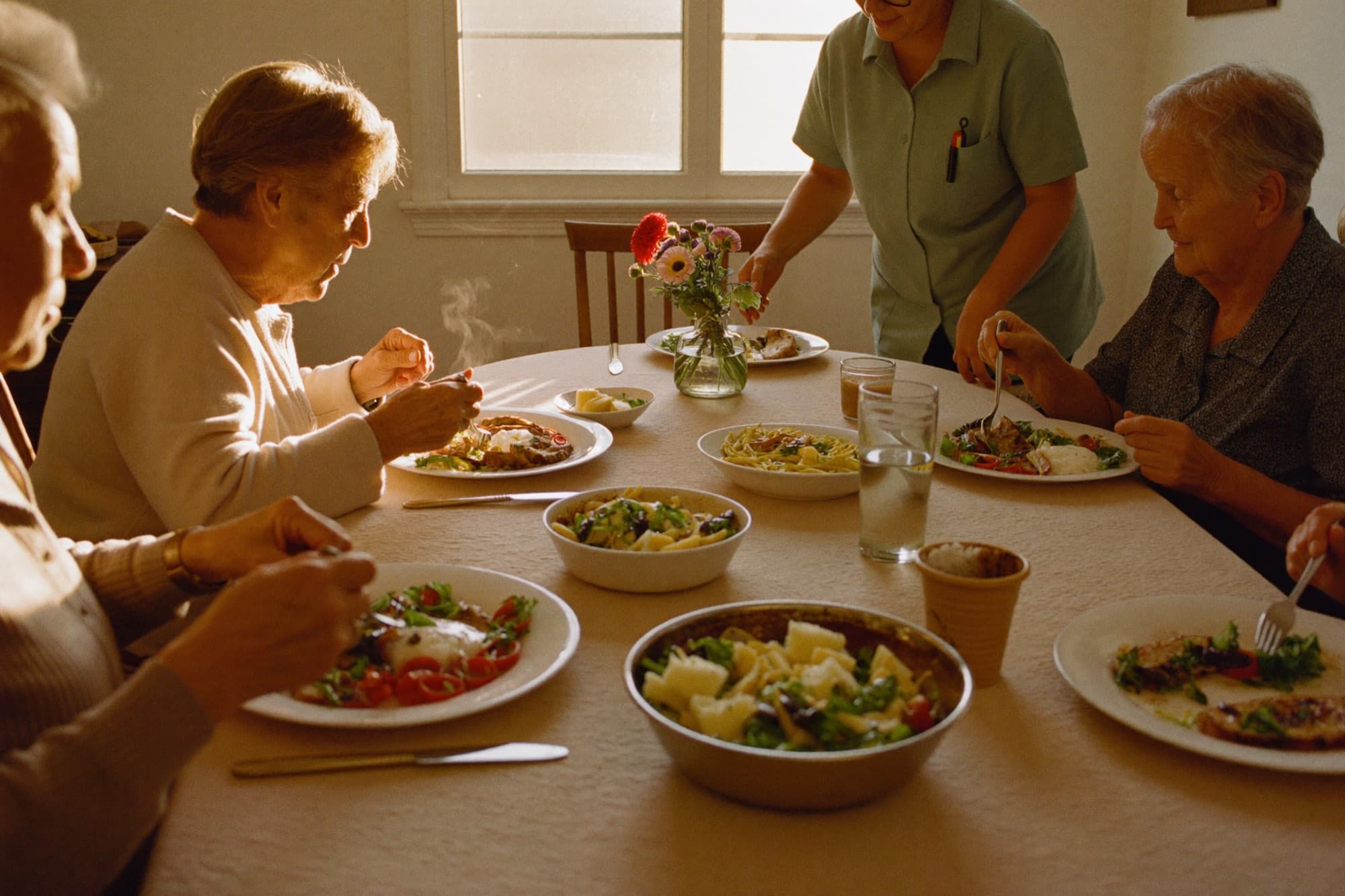A home-cooked, family-style meal shared around the dining table at Valrico Family Care Home
